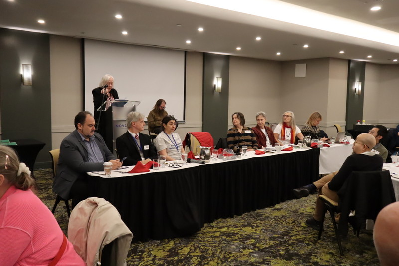 A panel sitting at a table